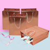 "Rose Gold Foil Gift Bags - 24 Pack with Twisted Handles - Perfect for Celebrations and Shopping"